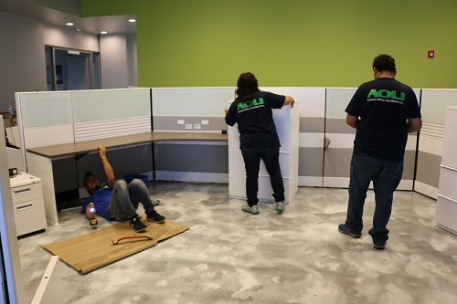 team members install cubicles