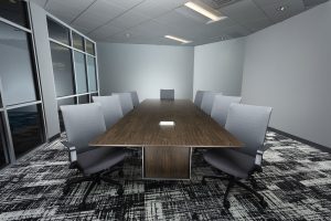 A brown table with grey chairs