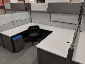 cubicle with an office chair and file cabinet