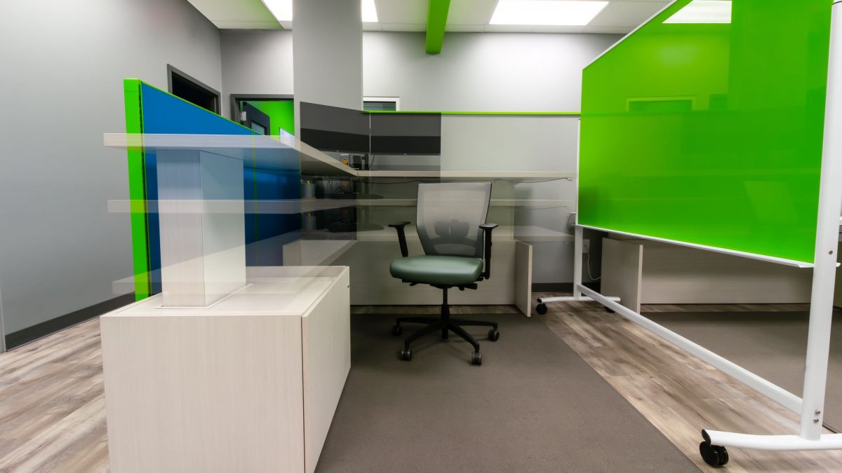 An office room with a green white board