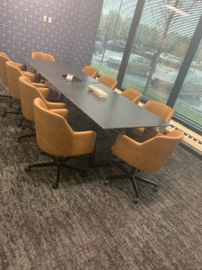 A table with orange chairs