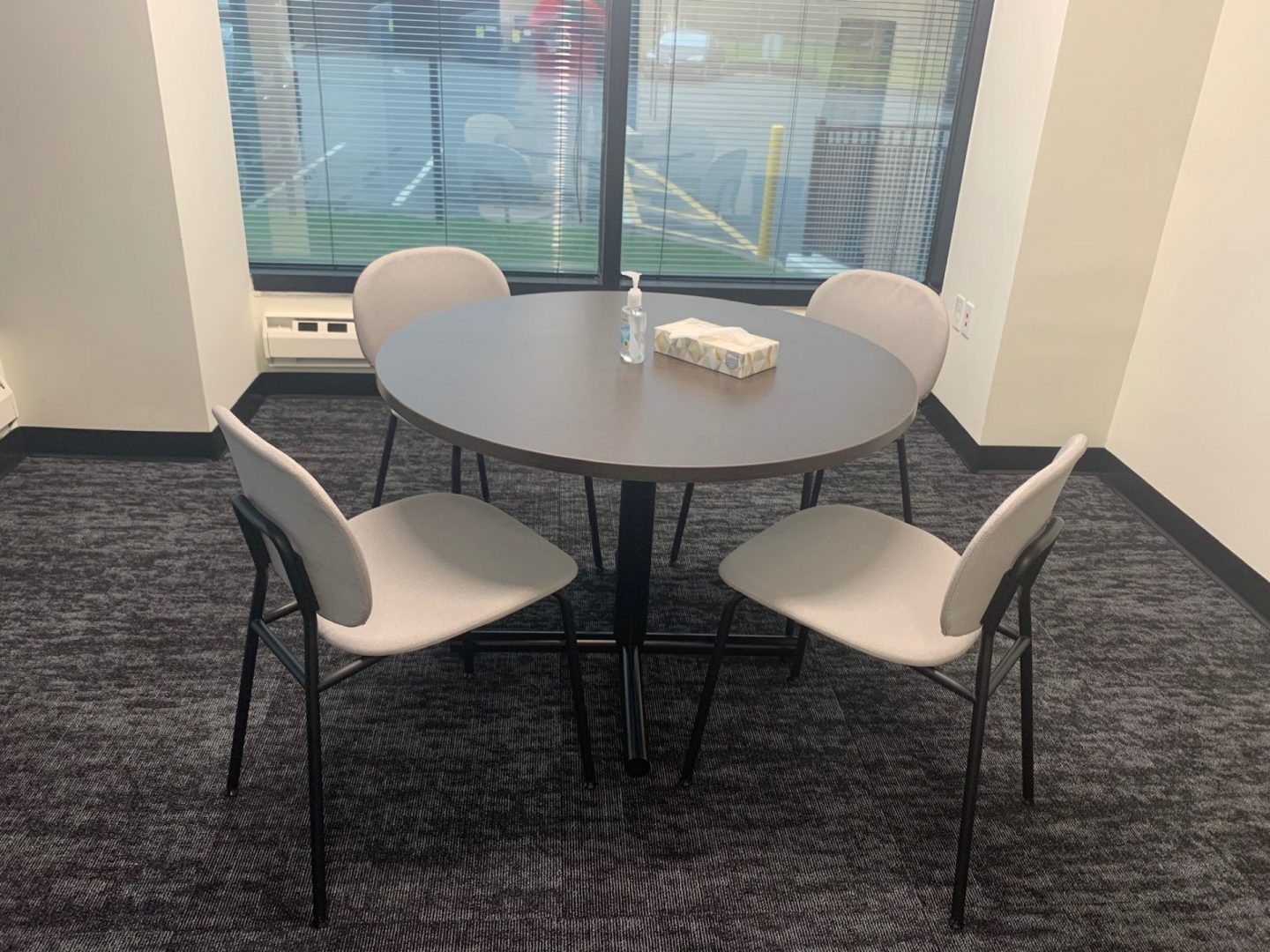 A round table with white chairs