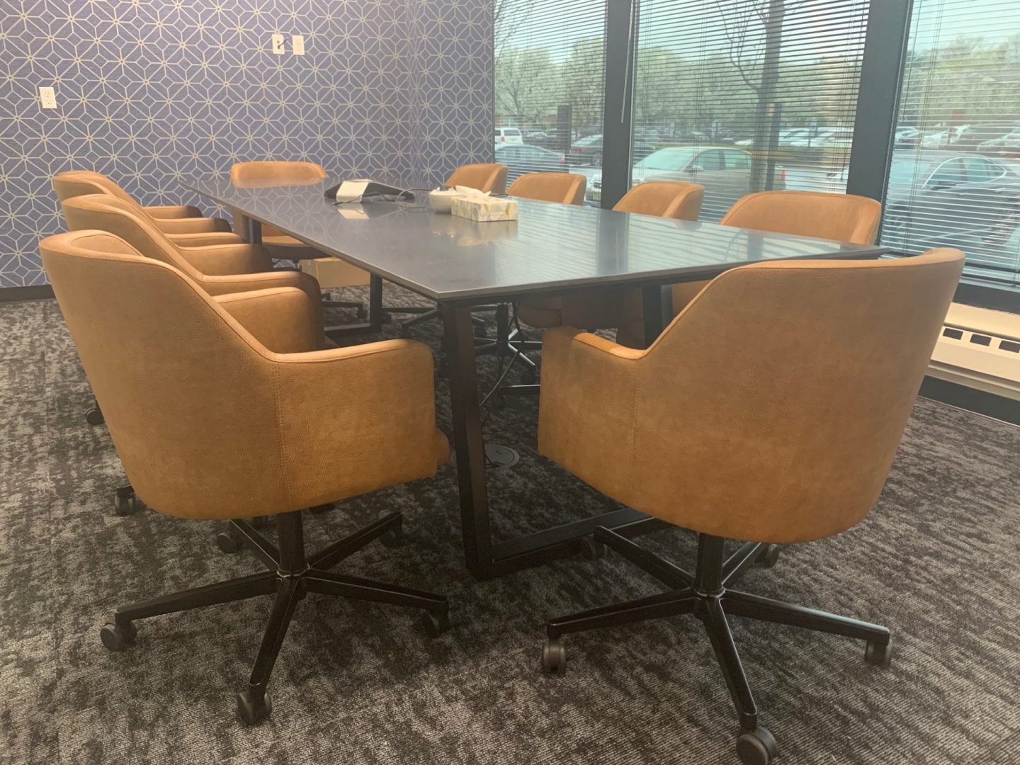A black table with orange chairs